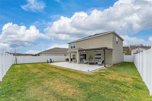 rear view of house with a lawn, ceiling fan, and a patio