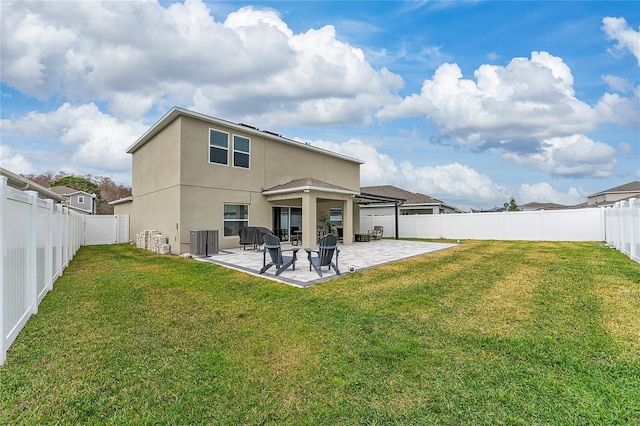 back of house with central AC unit, a patio area, and a yard