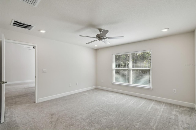 carpeted empty room featuring ceiling fan