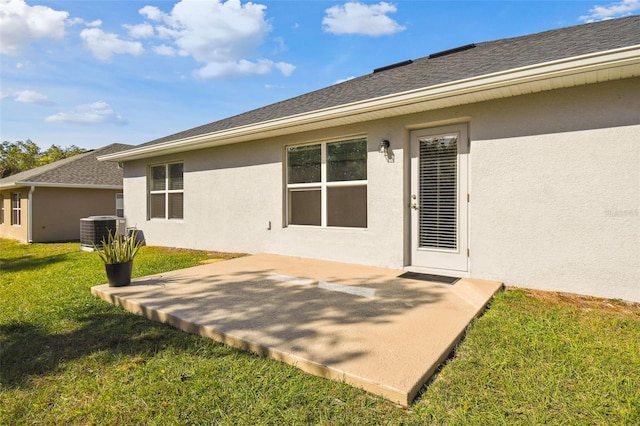 back of house with cooling unit, a lawn, and a patio