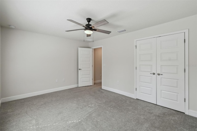 unfurnished bedroom featuring carpet flooring, ceiling fan, and a closet