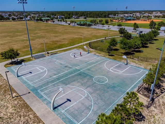 view of basketball court with a yard