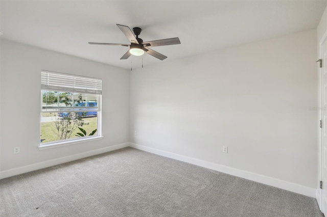 carpeted spare room featuring ceiling fan