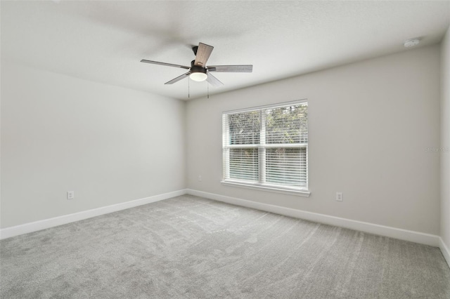 unfurnished room featuring light carpet and ceiling fan