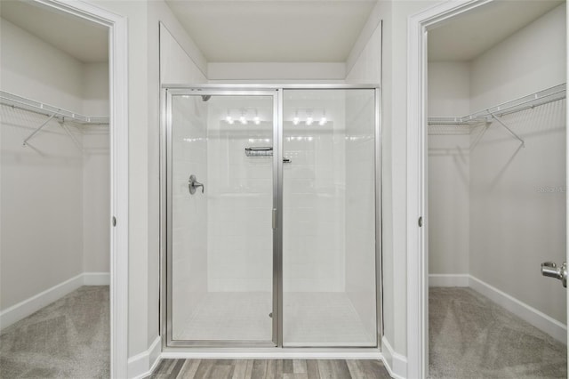 bathroom featuring hardwood / wood-style flooring and a shower with door