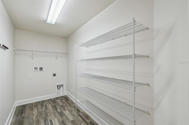 washroom with electric dryer hookup, dark hardwood / wood-style floors, washer hookup, and a textured ceiling