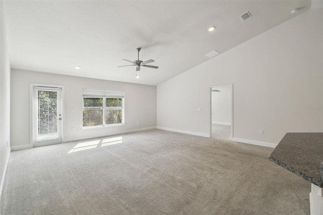 unfurnished living room with light carpet, lofted ceiling, and ceiling fan