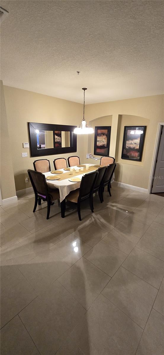 dining space featuring a textured ceiling and an inviting chandelier