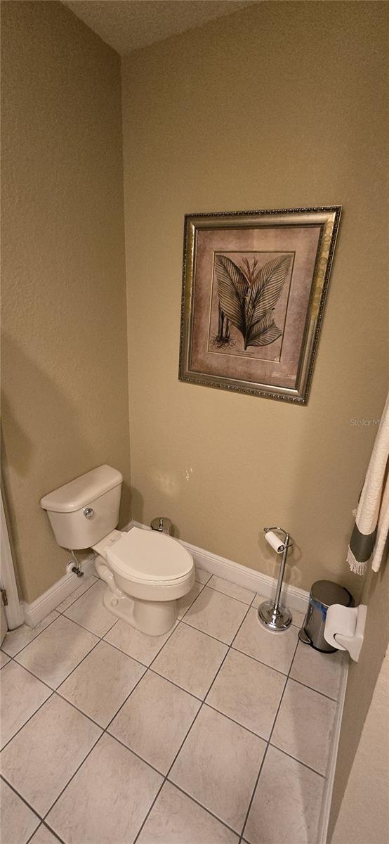 bathroom with toilet and tile patterned flooring