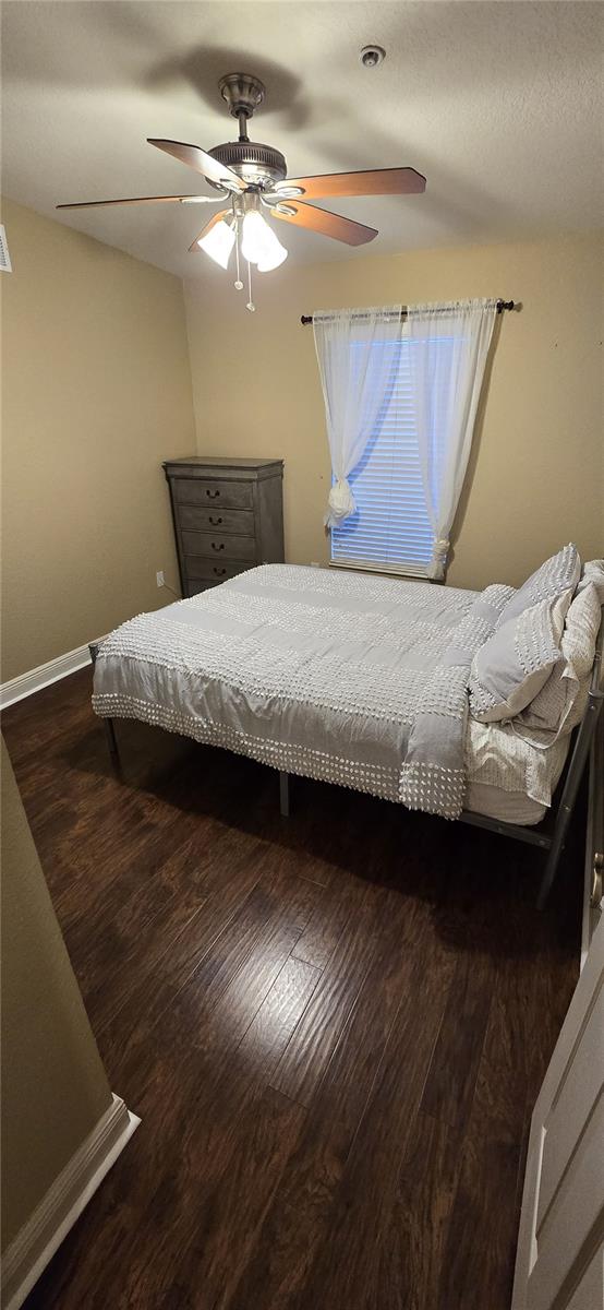 bedroom featuring ceiling fan and dark hardwood / wood-style flooring