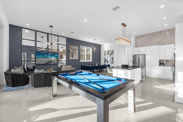 playroom with sink, a notable chandelier, billiards, and light tile patterned floors