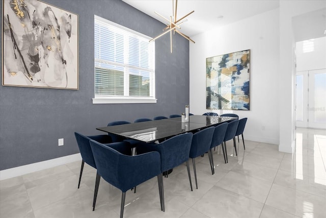 tiled dining room with a chandelier