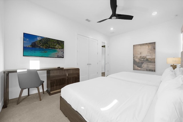 carpeted bedroom featuring a closet and ceiling fan