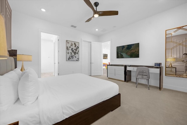 carpeted bedroom featuring ceiling fan and connected bathroom