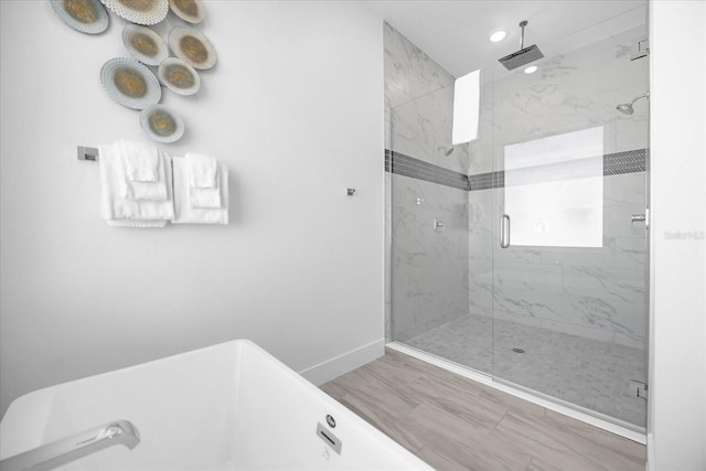 bathroom featuring hardwood / wood-style floors and a shower with door