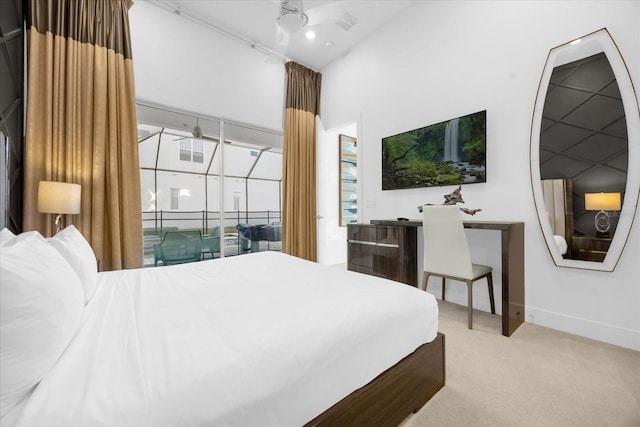 bedroom featuring ceiling fan, a high ceiling, and carpet