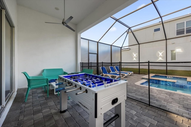 view of patio / terrace featuring an in ground hot tub, ceiling fan, a lanai, and an outdoor hangout area