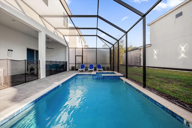 view of swimming pool featuring glass enclosure, an in ground hot tub, a patio area, and a yard