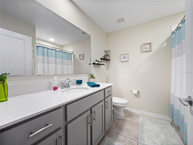 bathroom with toilet, tile patterned flooring, walk in shower, and vanity