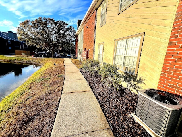 view of side of property featuring central AC