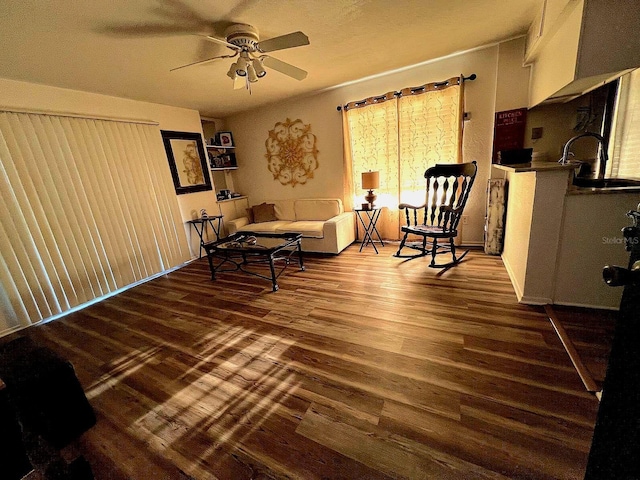 living room with ceiling fan, sink, and wood-type flooring