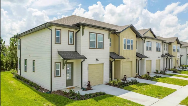 view of front of house with a garage and a front yard