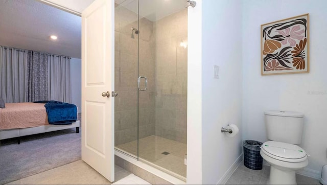 bathroom featuring toilet, tile patterned floors, and an enclosed shower