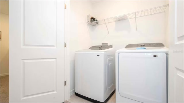 laundry room featuring washing machine and clothes dryer