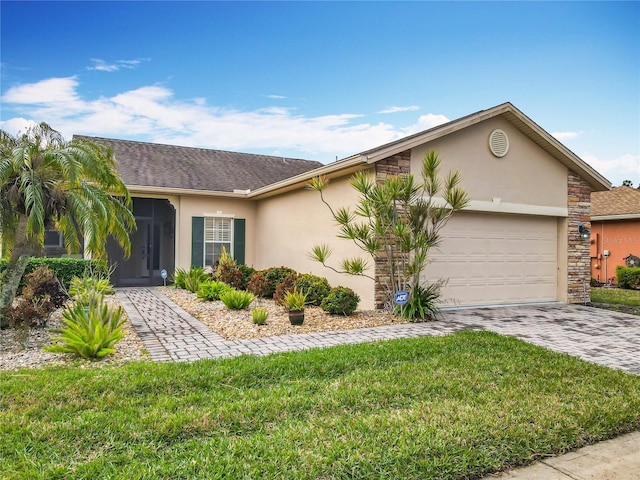 single story home featuring a garage and a front lawn