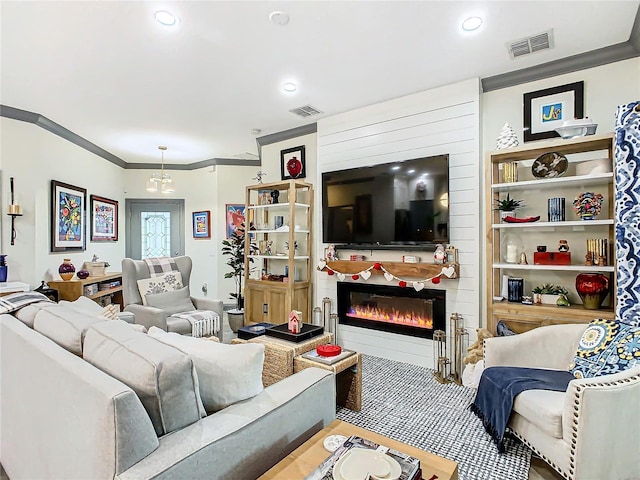 living room with ornamental molding and a fireplace