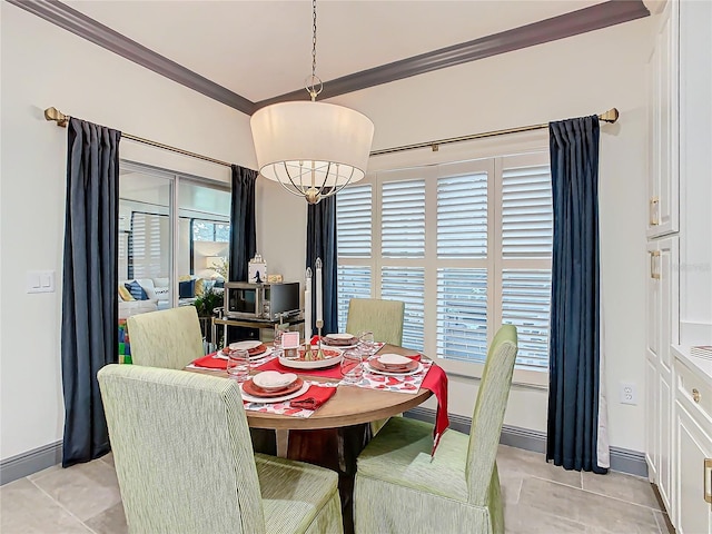 dining space featuring light tile patterned floors, crown molding, and a notable chandelier