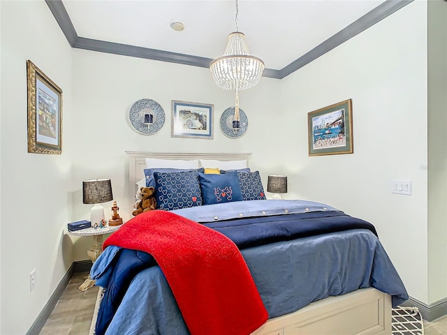 bedroom featuring ornamental molding, wood-type flooring, and a notable chandelier