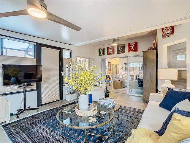 tiled living room featuring beam ceiling and ceiling fan