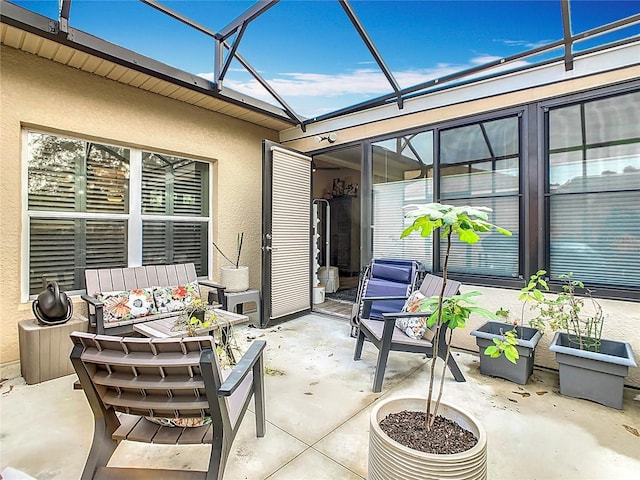 view of patio featuring glass enclosure