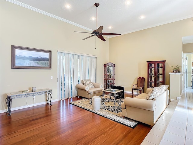 living room with ceiling fan, ornamental molding, and light wood-type flooring