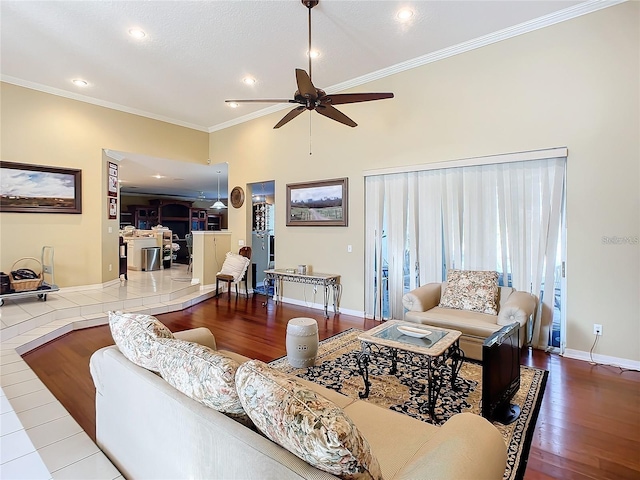 living room with ceiling fan, crown molding, and wood-type flooring