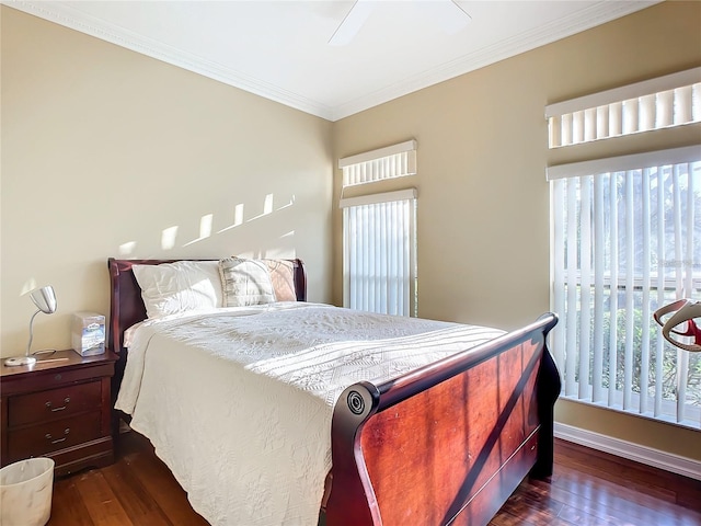 bedroom with dark hardwood / wood-style flooring, ceiling fan, and ornamental molding