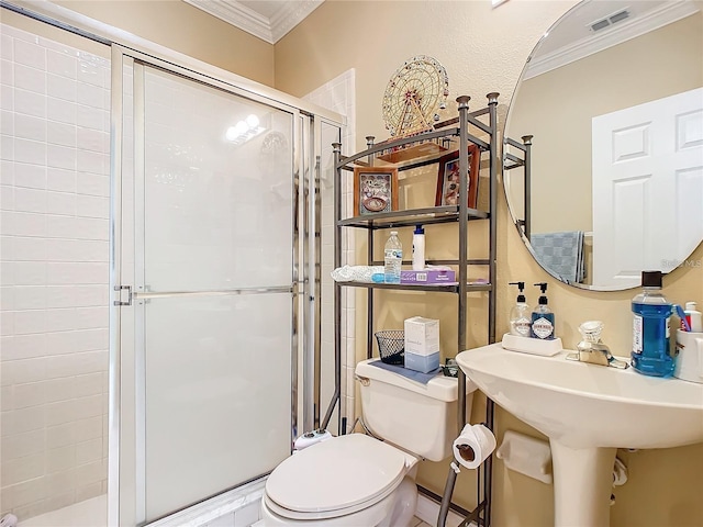 bathroom featuring a shower with door, toilet, and ornamental molding