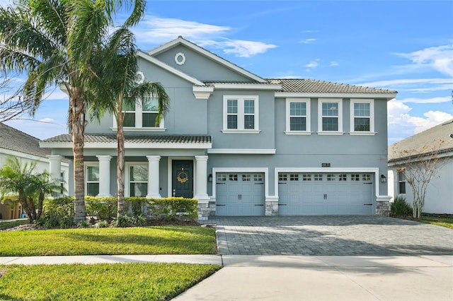 view of front of house featuring a garage and a front lawn