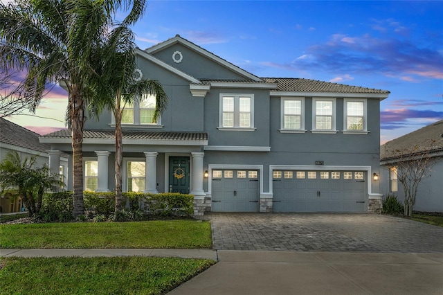 view of front of house with a yard and a garage