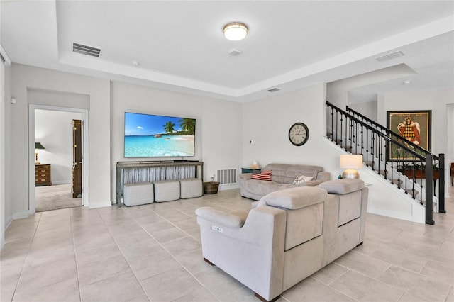 tiled living room with a raised ceiling