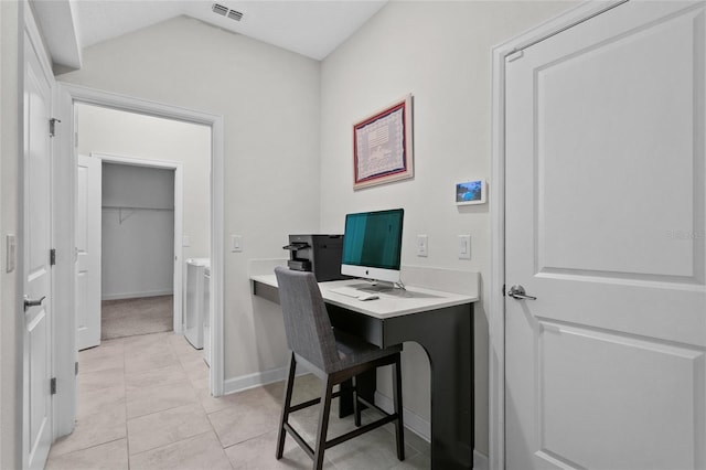 home office with lofted ceiling and light tile patterned flooring