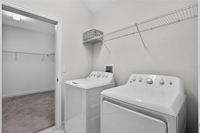 laundry area with light colored carpet and washer and clothes dryer