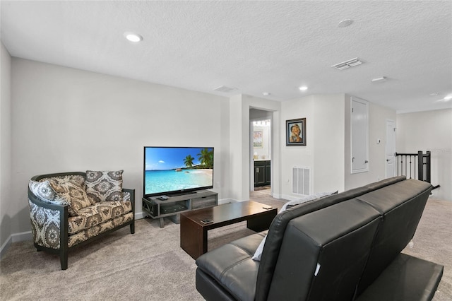 carpeted living room with a textured ceiling