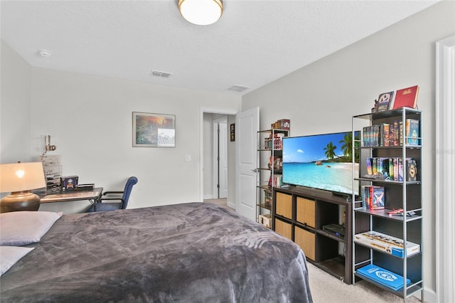 carpeted bedroom featuring a textured ceiling