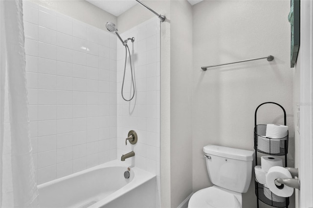 bathroom featuring toilet and shower / bath combination with curtain