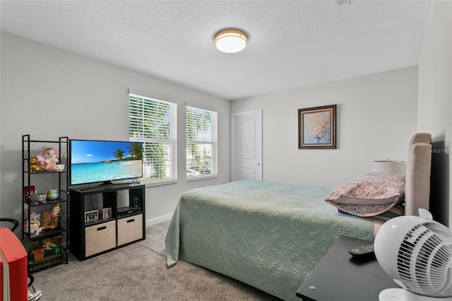 carpeted bedroom featuring a textured ceiling