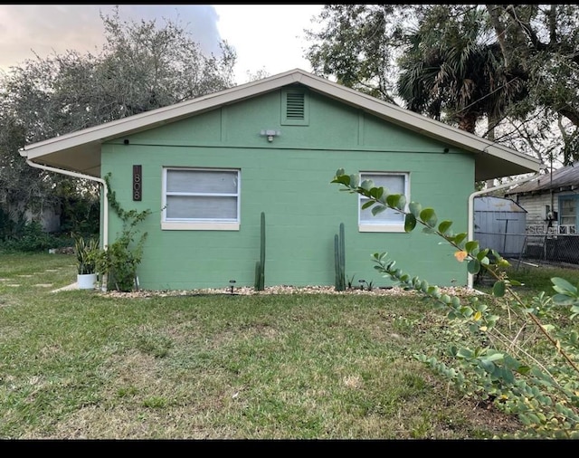 view of side of home featuring a lawn