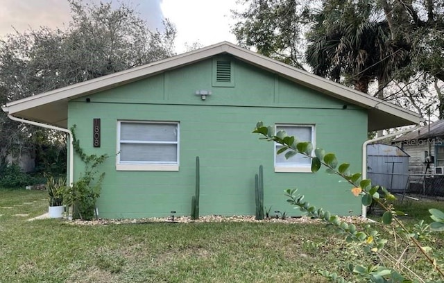 view of property exterior with a lawn