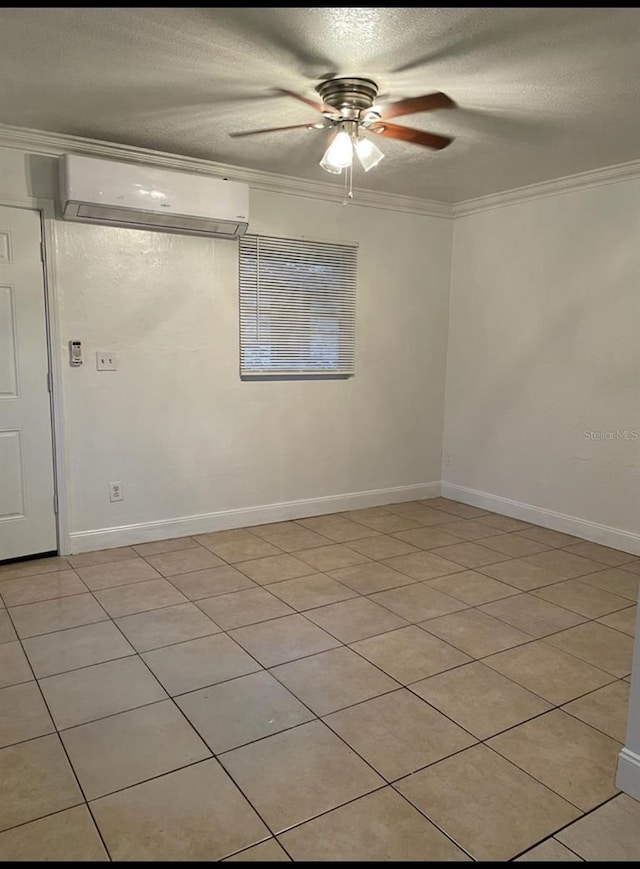 spare room featuring a textured ceiling, crown molding, light tile patterned flooring, and a wall mounted AC